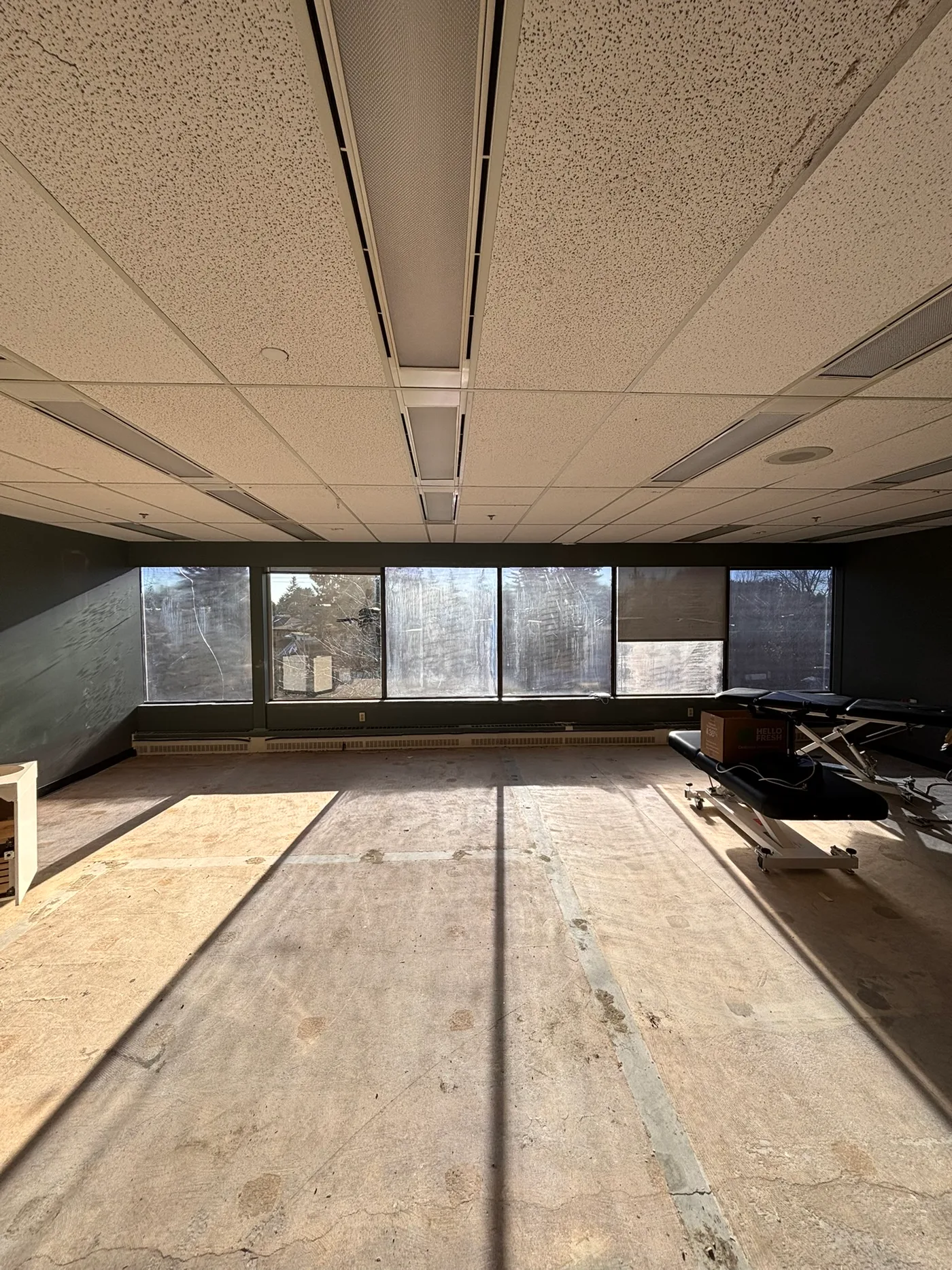 Magnus Health raw space before renovation — open concrete floor and large windows